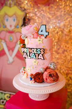 a pink princess's birthday cake with decorations on top