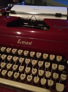 an old fashioned typewriter sitting on top of a table