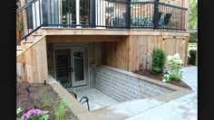 an outside view of a house with stairs and railings leading to the upper level