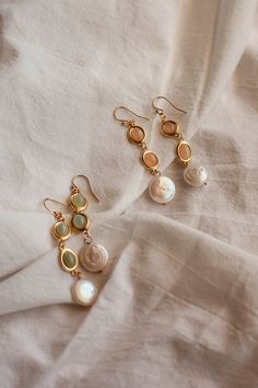 Radiate with the glow of sun-kissed shores with these enchanting Sunstone and Prehnite dangle earrings, artistically adorned with a freshwater pearl at the bottom. This pair of earrings embodies the vibrant hues of a sunny beach day and the mystical allure of the sea. The warmth of the gemstones, paired with the coolness of the freshwater pearl, creates the perfect balance.  All earrings are madew using Gold-Filled earwire. Gold-filled pieces are stunning jewels that are second to pure gold. The Italian Summer Jewelry, Boho Pearl Earrings, Gold Earrings Long, Sunny Beach Day, Sunstone Earrings, Beach Earrings, Freshwater Pearl Earrings, Long Drop Earrings, Sunny Beach