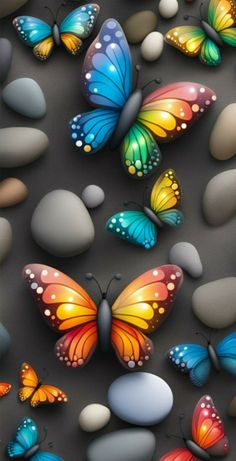 many different colored butterflies flying over rocks