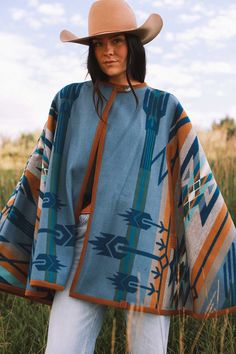 Bringing back the fun and sensible style of a cape, this will keep you just the right temperature while you’re out and about. Our cape is reversible, offering two wearing options displaying different hues of blue. Made with the Pendleton® Star Watchers wool blanket. Since ancient times, Native Americans have practiced astronomy to predict the arrival of the brightest stars. Mysterious medicine wheels in Wyoming and Canada track the rising of Aldebaran, Rigel and Sirius, inspiring this dynamic de One Size Outdoor Cape Outerwear, One Size Cape For Outdoor, One Size Outdoor Cape, Blue Cape For Fall, Blue Fall Cape Outerwear, One Size Wool Cape Outerwear, Blue Shawl Cape For Fall, Winter Blue One-size Outerwear, Blue One-size Cape