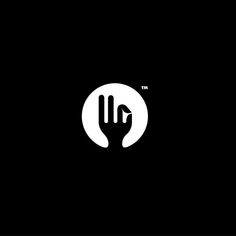 a black and white logo with a hand in the middle