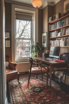 an office with a desk, chair and bookshelf in front of a window