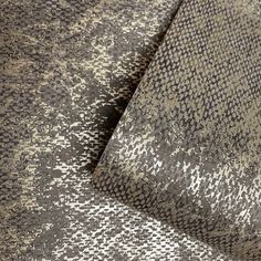 an upholstered fabric textured with grey and white speckles