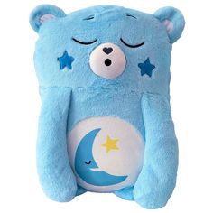 a blue teddy bear with stars and moon on it's chest, sitting up against a white background