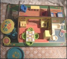 a doll house with furniture and accessories on the floor