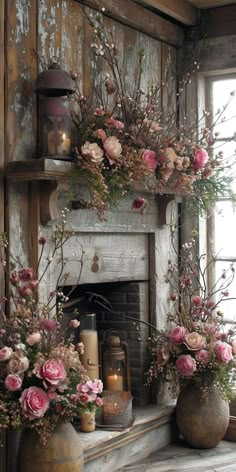 two vases filled with flowers on top of a mantle