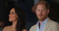 prince harry and his wife, the duke of cambridge are looking at something while standing next to each other