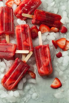 popsicles with strawberries and ice on a table