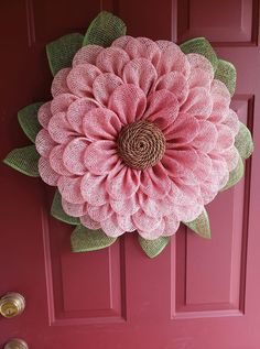 a pink door with a large flower on it