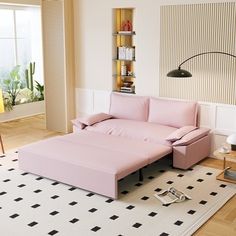 a living room filled with furniture and a pink couch on top of a white rug