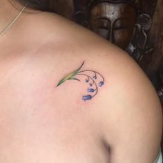 a close up of a woman's breast with blue flowers on her left side