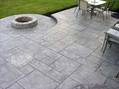 a fire pit sitting on top of a cement patio