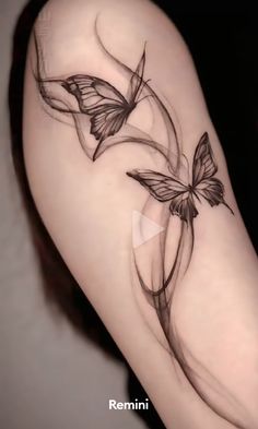 a woman's thigh with two butterflies on it