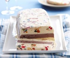 two pieces of cake sitting on top of a white plate with blue and white napkins