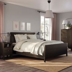 a bed room with a neatly made bed next to a dresser and window sill