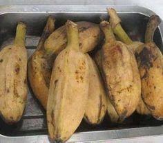 some bananas are sitting in a metal pan