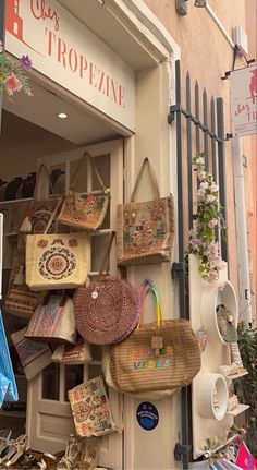 a store front with baskets and purses on display