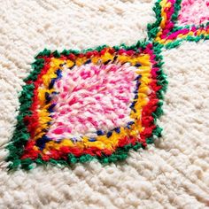 a crocheted rug with two squares on it