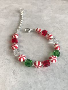 This bracelet is made with peppermint beads, silver colored spacers, silver colored lobster claw clasp with extender, and green, red, and clear square crystals. The bracelet has an extender making any size between 7-9 inches long. This bracelet is perfect for the holiday season. If you have any questions or concerns feel free to contact owner and designer at HannahsJeweltique@gmail.com  Visit my website at HannahsJeweltique.com Christmas Bracelet Ideas, Holiday Beaded Jewelry, Christmas Jewelry Diy, Pumpkin Pin, Christmas Beading, Christmas Jewellery, Jewelry Making Bracelet, Christmas Bead, Christmas Bracelet