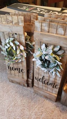 three wooden crates with flowers and welcome signs on them