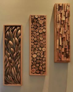 three pieces of art made out of wood are hanging on the wall next to each other