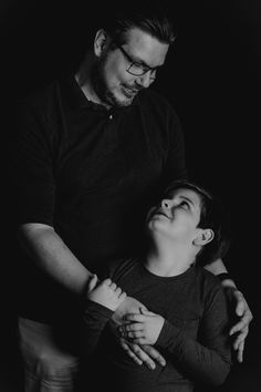 black and white photograph of a man holding a woman's arm in the dark