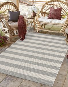 a white and gray striped rug sitting on top of a patio