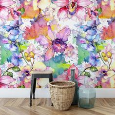 a wall with flowers painted on it in front of a basket and stool next to the floor