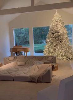 a living room filled with furniture and a christmas tree