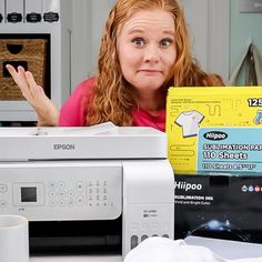 a woman sitting in front of a microwave with her hand on the top of it