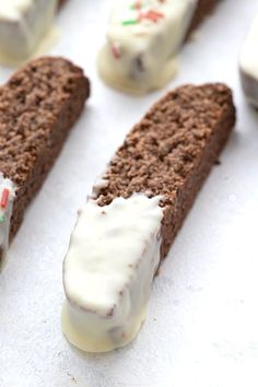 chocolate cake with white frosting and sprinkles sitting on a baking sheet