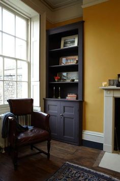 a living room filled with furniture and a fire place in front of a large window