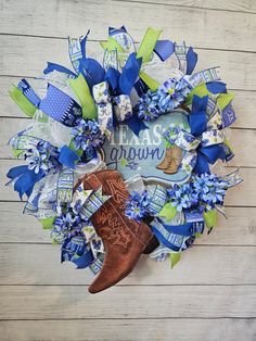 a wreath with cowboy boots and blue flowers