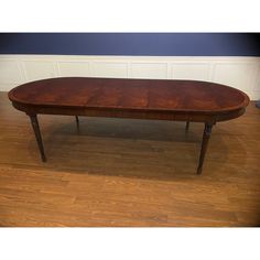 a wooden table sitting on top of a hard wood floor next to a blue wall