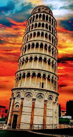 the leaning tower is in front of an orange and blue sky with clouds above it