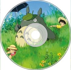 the dvd cover for totoro and his friends in the grass with an umbrella