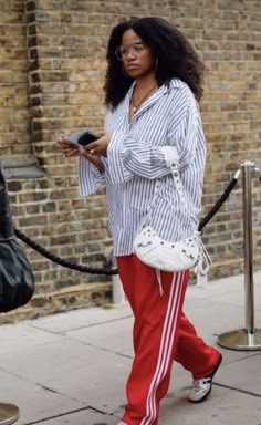 Red Track Jacket For Spring Streetwear, Sporty Red Pants For Spring, Layering With Dresses, Adidas Track Pants Outfit Woman, Adut Akech Street Style, Courtside Outfit Basketball, Adidas Joggers Outfit, Sporty Red Joggers For Streetwear, Red Adidas Pants