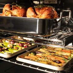 two pans filled with food sitting on top of an oven