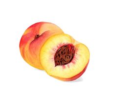 two peaches cut in half on a white background