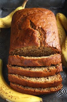 a loaf of banana bread sitting next to some bananas