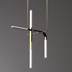 a modern chandelier hanging from the ceiling with two white and gold bars attached to it