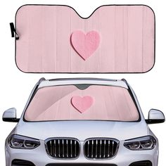 a car with two pink hearts on the front and back windshield window coverings,