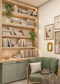 a green chair sitting in front of a book shelf filled with books and other items