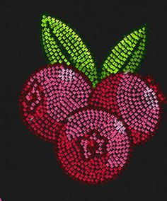 an apple and two cherries made out of sequins on a black background