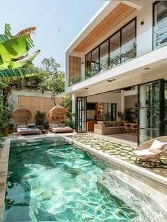 an outdoor swimming pool in front of a house