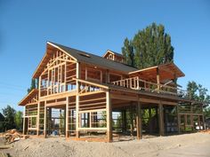 a large wooden house under construction with lots of windows