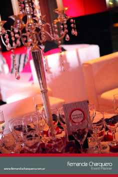 a table with wine glasses and a chandelier