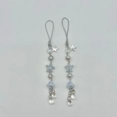 pair of dangling earrings with pearls and stars